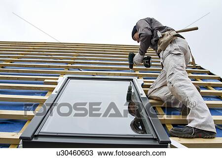 Stock Image - Builder at work on new structure. Fotosearch