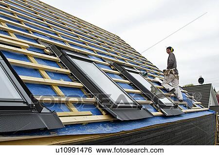 Stock Photograph - Builder at work on new structure. Fotosearch