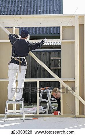 Builders at work on new structure View Large Photo Image Stock Photo - Builders at work on new structure. Fotosearch