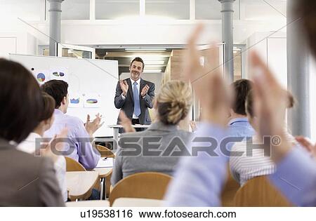 Stock Photograph - Business people applauding at seminar. Fotosearch