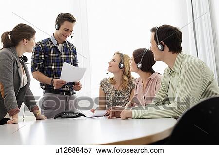 Business people in headsets in meeting View Large Photo Image Stock Photo - Business people in headsets in meeting. Fotosearch