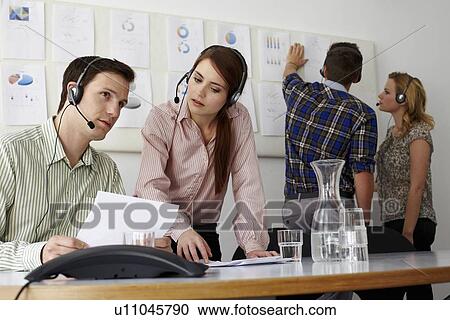 Business people in headsets in office View Large Photo Image Stock Image - Business people in headsets in office. Fotosearch