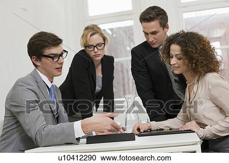 Stock Image - Business people playing board games. Fotosearch