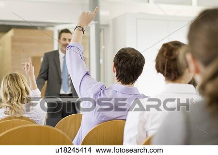Business people raising hands in seminar View Large Photo Image Picture - Business people raising hands in seminar. Fotosearch