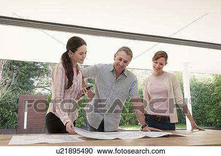 Business people reading blueprints View Large Photo Image Stock Image - Business people reading blueprints. Fotosearch