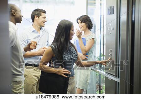 Business people riding glass elevator View Large Photo Image Stock Photography - Business people riding glass elevator. Fotosearch