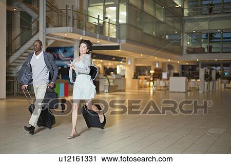 Business people running in lobby View Large Photo Image Stock Image - Business people running in lobby. Fotosearch