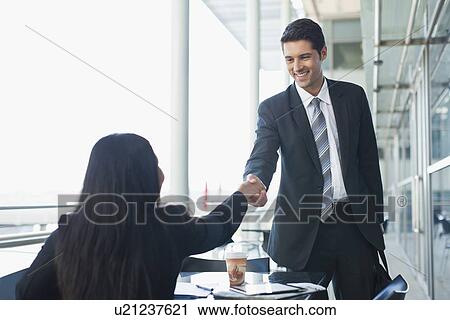 Business people shaking hands in cafe View Large Photo Image Stock Image - Business people shaking hands in cafe. Fotosearch
