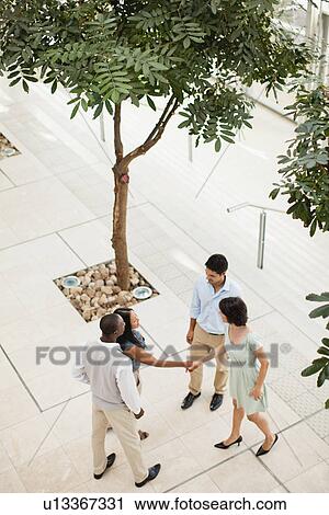 Business people shaking hands in lobby View Large Photo Image Stock Image - Business people shaking hands in lobby. Fotosearch