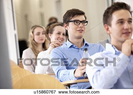 Business people sitting at desks View Large Photo Image Stock Photo - Business people sitting at desks. Fotosearch