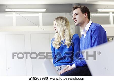 Stock Photograph - Business people sitting in office. Fotosearch