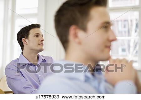 Stock Photo - Business people sitting in seminar. Fotosearch