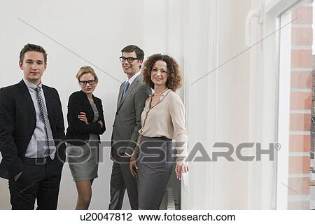 Business people smiling in office View Large Photo Image Stock Image - Business people smiling in office. Fotosearch