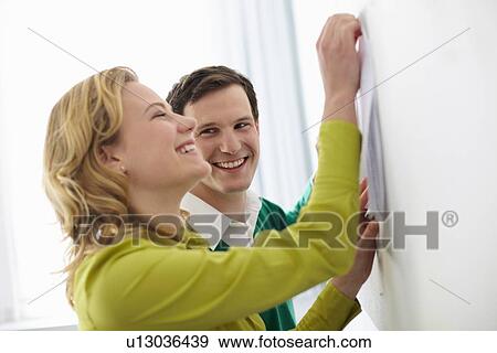 Business people tacking up signs View Large Photo Image Stock Photo - Business people tacking up signs. Fotosearch