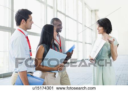 Business people talking in lobby View Large Photo Image Stock Image - Business people talking in lobby. Fotosearch