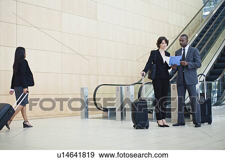 Business people talking in lobby View Large Photo Image Stock Photo - Business people talking in lobby. Fotosearch