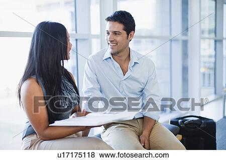 Stock Photo - Business people talking in lobby. Fotosearch