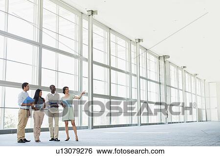 Business people talking in lobby View Large Photo Image Stock Photograph - Business people talking in lobby. Fotosearch