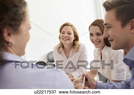 Stock Photo - Business people talking in meeting. Fotosearch
