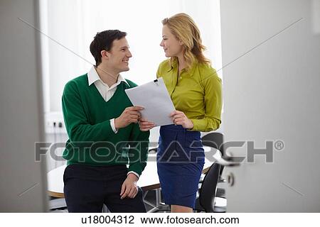 Stock Image - Business people talking in office. Fotosearch