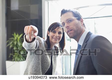 Stock Image - Business people talking in office. Fotosearch