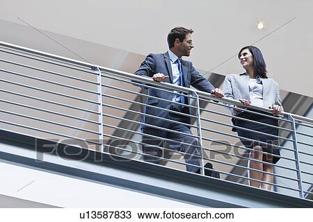 Business people talking on balcony View Large Photo Image Stock Image - Business people talking on balcony. Fotosearch