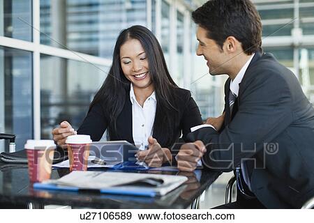 Business people using tablet computer View Large Photo Image Stock Photo - Business people using tablet computer. Fotosearch