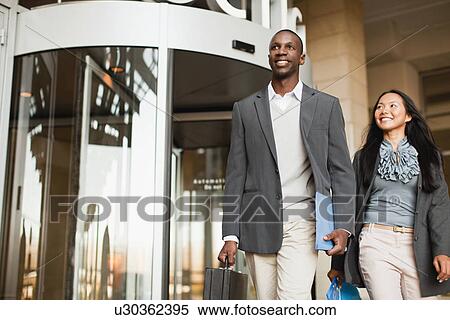 Business people walking outside building View Large Photo Image Stock Photography - Business people walking outside building. Fotosearch