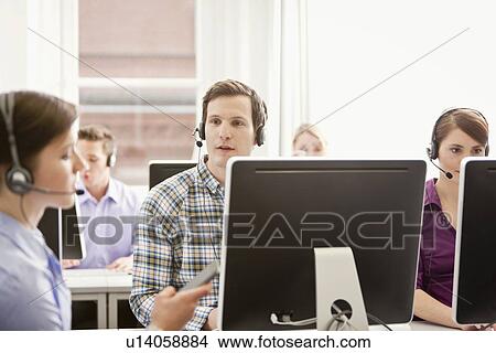 Picture - Business people working in headsets. Fotosearch
