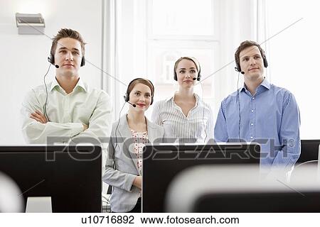 Stock Image - Business people working in headsets. Fotosearch