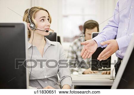Stock Image - Business people working in headsets. Fotosearch