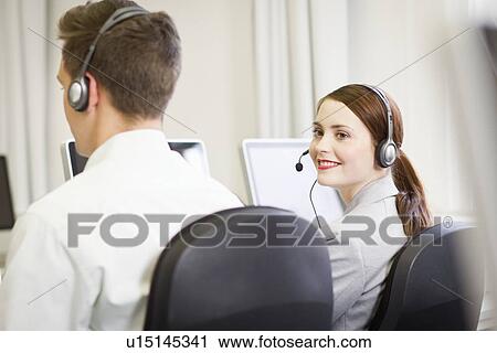 Business people working in headsets View Large Photo Image Stock Image - Business people working in headsets. Fotosearch