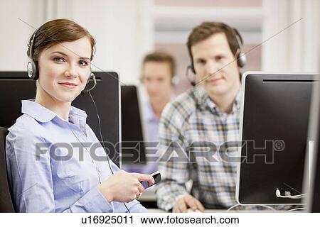 Stock Image - Business people working in headsets. Fotosearch