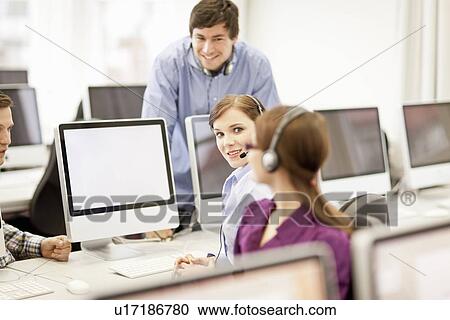 Business people working in headsets View Large Photo Image Stock Image - Business people working in headsets. Fotosearch