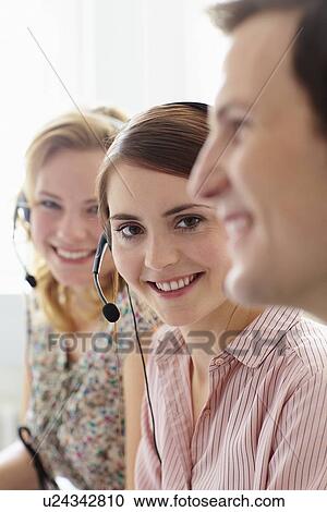 Business people working in headsets View Large Photo Image Stock Image - Business people working in headsets. Fotosearch