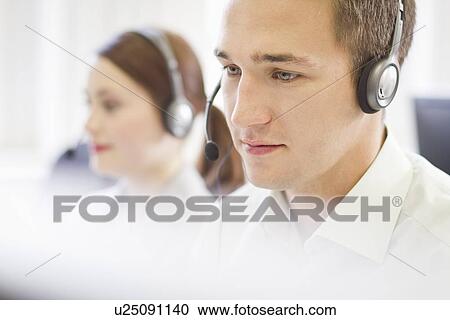 Business people working in headsets View Large Photo Image Stock Image - Business people working in headsets. Fotosearch