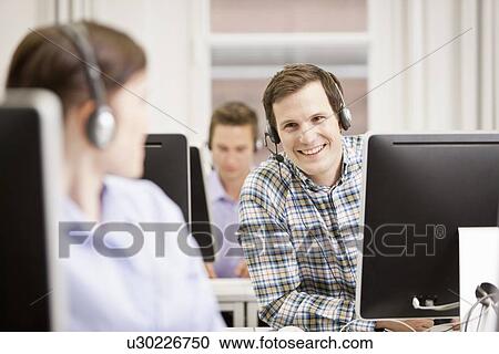 Business people working in headsets View Large Photo Image Stock Image - Business people working in headsets. Fotosearch