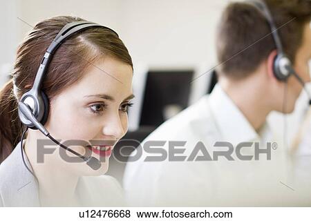 Stock Photo - Business people working in headsets. Fotosearch