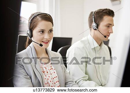 Business people working in headsets View Large Photo Image Stock Photo - Business people working in headsets. Fotosearch