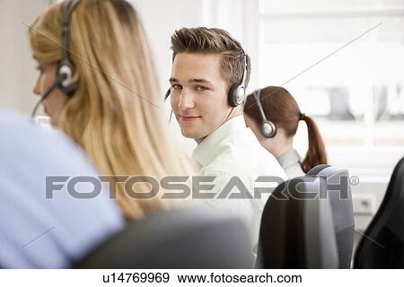 Stock Photo - Business people working in headsets. Fotosearch