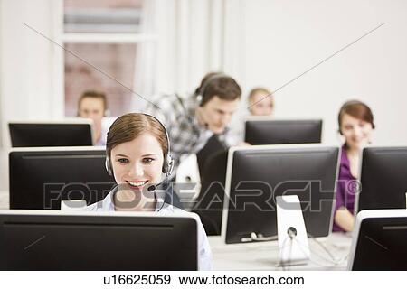 Stock Photo - Business people working in headsets. Fotosearch