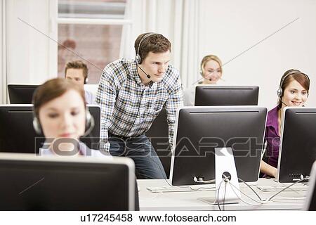 Stock Photo - Business people working in headsets. Fotosearch