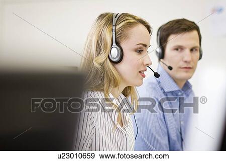 Stock Photo - Business people working in headsets. Fotosearch