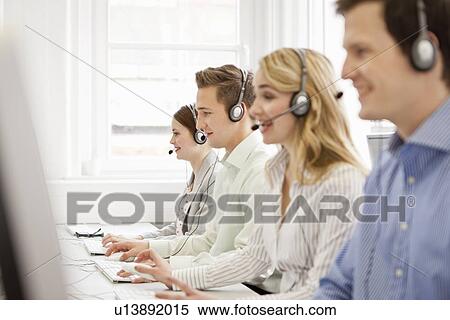 Business people working in headsets View Large Photo Image Stock Photography - Business people working in headsets. Fotosearch