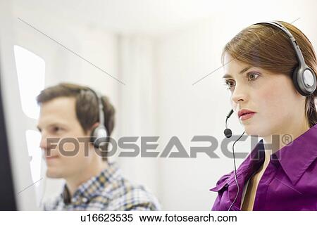Stock Photography - Business people working in headsets. Fotosearch