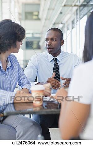 Business people working together in cafe View Large Photo Image Picture - Business people working together in cafe. Fotosearch