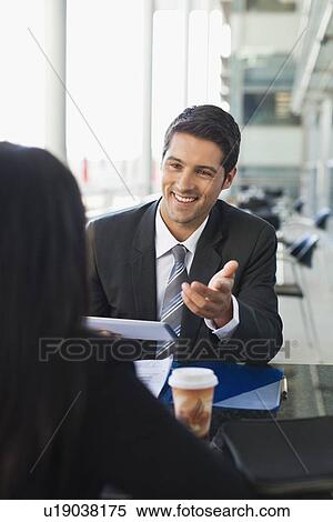 Stock Photography - Business people working together in cafe. Fotosearch