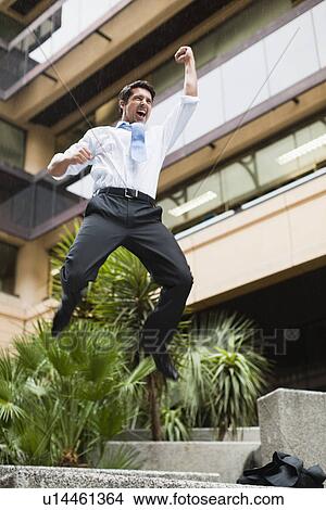 Businessman jumping for joy outdoors View Large Photo Image Picture - Businessman jumping for joy outdoors. Fotosearch
