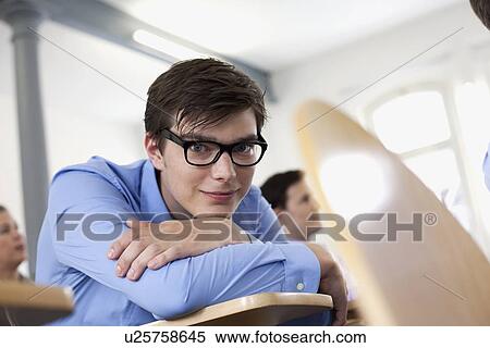 Businessman resting chin on arms View Large Photo Image Stock Photography - Businessman resting chin on arms. Fotosearch