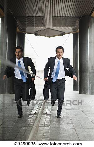 Businessman running on city street View Large Photo Image Stock Photography - Businessman running on city street. Fotosearch